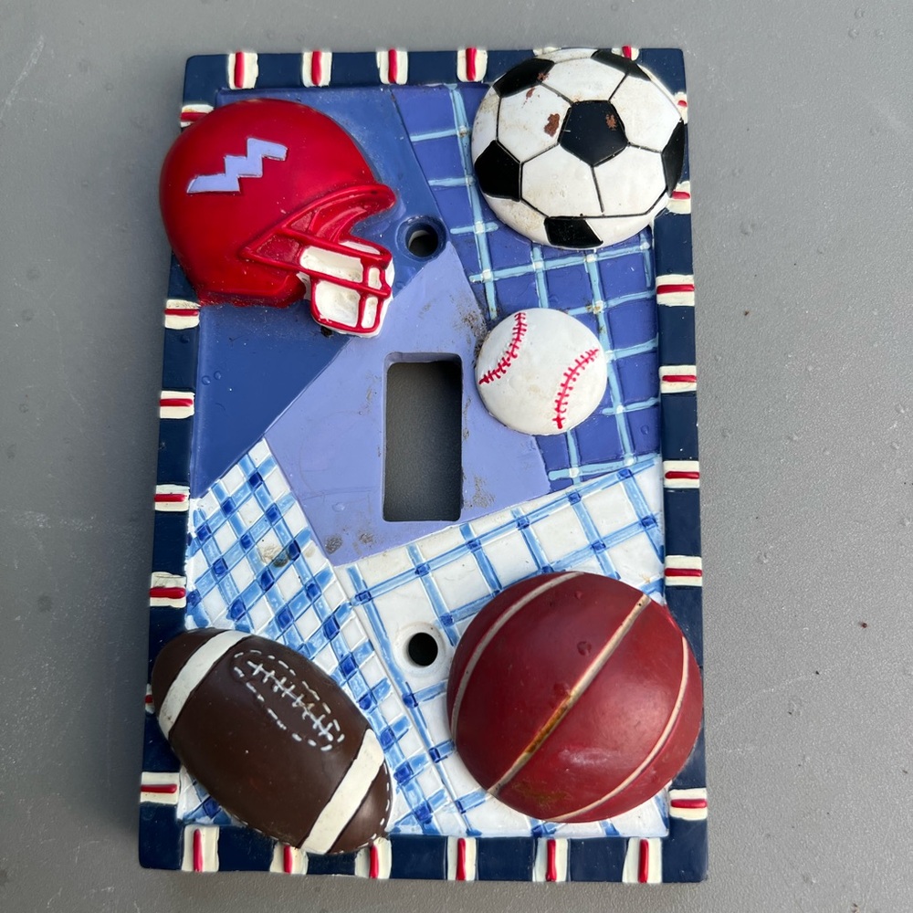 Wall switch plate featuring ball theme
